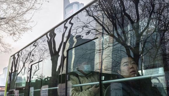 Passengers ride a bus in Beijing, China, on Tuesday, Jan. 2, 2024. Chinese President Xi Jinping pledged to strengthen economic momentum and job creation, acknowledging some companies and citizens had endured a difficult 2023 in a rare admission of domestic headwinds facing the country.