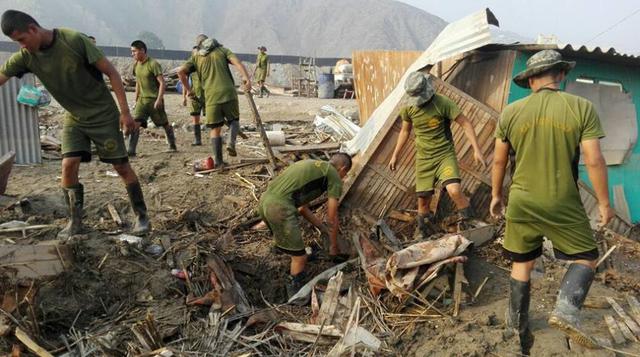 Otros miembros del Ejército se encargan de apoyar a quienes vieron destruidas sus viviendas por los huaicos.
