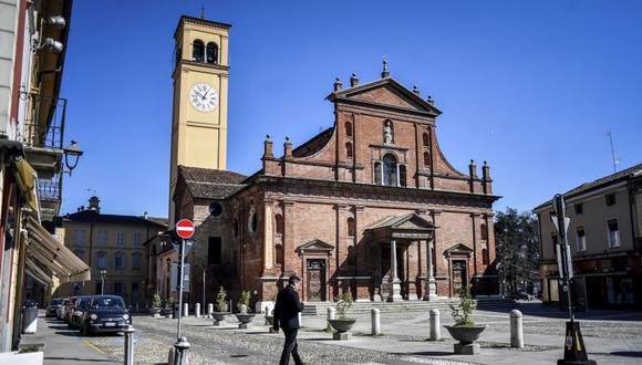 A man walks in the square of Codogno, in the region of Lombardia, northern Italy, Wednesday, March 11, 2020. The Lombardy cluster of COVID-19 was first registered in the tiny town of Codogno on Feb. 19, when the first patient tested positive and has been a red zone until the end of seclusion and return of production in the recent days. For most people, the new coronavirus causes only mild or moderate symptoms, such as fever and cough. For some, especially older adults and people with existing health problems, it can cause more severe illness, including pneumonia. (Claudio Furlan/LaPresse via AP)