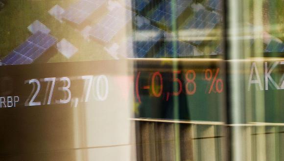 Stock price information reflected on a window at the Euronext NV stock exchange in Paris. Photographer: Nathan Laine/Bloomberg