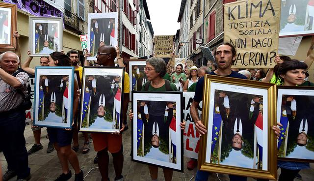 Activistas marcharon con el retrato de Emmanuel Macron boca abajo. (Foto: AFP)