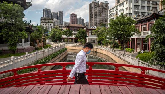 Un hombre que lleva mascarilla cruza un puente en Guangzhou. EFE/EPA/ALEX PLAVEVSKI
