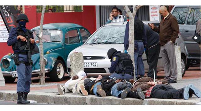 Ciudad Del Cabo, Sudáfrica. Homicidios: 2.244. Población: 3.740.026. Tasa de homicidios: 60.00. En la imagen: la policía vigila a seis sospechosos arrestados por un supuesto robo armado en el centro de Ciudad del Cabo.