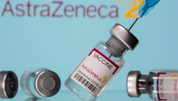 En esta foto ilustrativa tomada el 14 de marzo de 2021, se ven viales etiquetados como "Vacuna contra el coronavirus COVID-19 AstraZeneca" y una jeringa frente al logotipo de la farmacéutica. (REUTERS/Dado Ruvic/Illustration).