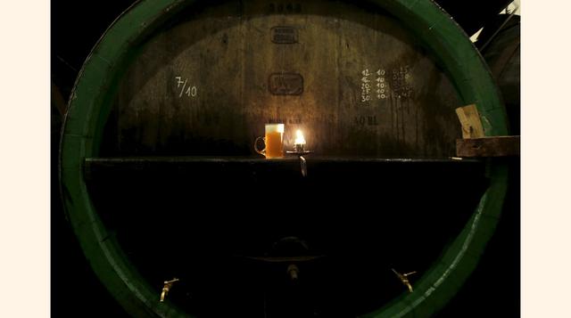Aquí se ve un vaso de cerveza sin pasteurizar sobre un barril en la cervecería Plzenský Prazdroj (Pilsner Urquell) en Plzen, República Checa. AB InBev también llegó a un acuerdo para vender la participación de 58% de SABMiller en el emprendimiento conjunt