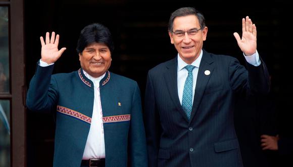 Peruvian President Martin Vizcarra (R) and his Bolivian counterpart Evo Morales wave at the press upon the latters' arrival at the presidential palace in Lima on May 26, 2019 in the framework of the Andean Community of Nations (CAN) Summit, on the 50th anniversary of its creation. (AFP)