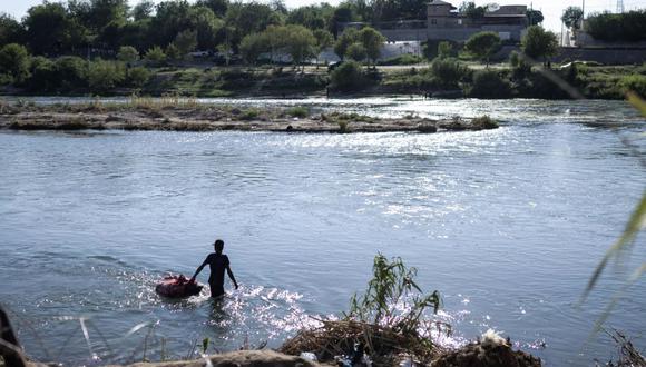 Marco Antonio González acostumbraba a pescar en el Río Grande, la frontera natural entre Estados Unidos y México, hasta que encontró otra forma de ganarse el sustento en medio de la llegada de cientos de migrantes a diario a estas orillas. (Foto: AFP)