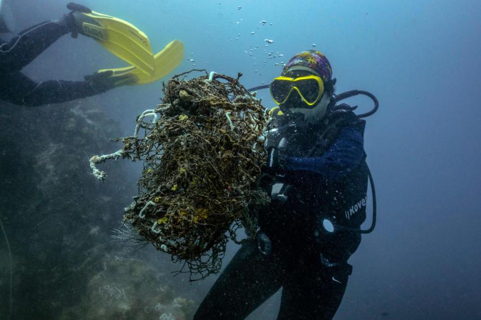 En la fotografía, unos buzos recogen redes de pesca usadas del fondo del mar cerca de la costa de la provincia tailandesa de Chon Buri, al sur del país. (Foto: Lillian Suwanrumpha / AFP / Getty Images).