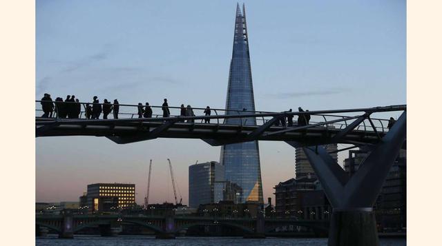 he Shard Building catches the early evening light as tourists cross the millennium bridge in London; El edificio Shard al atardecer observado por turistas que cruzan el puente del Milenio en Londres.(foto:Peter Nicholls).