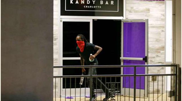 Un hombre sale de un local con botellas de alcohol. (foto: reuters).