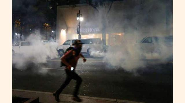 La gente corre ante las granadas de humo que lanza la Policía. (foto: reuters).