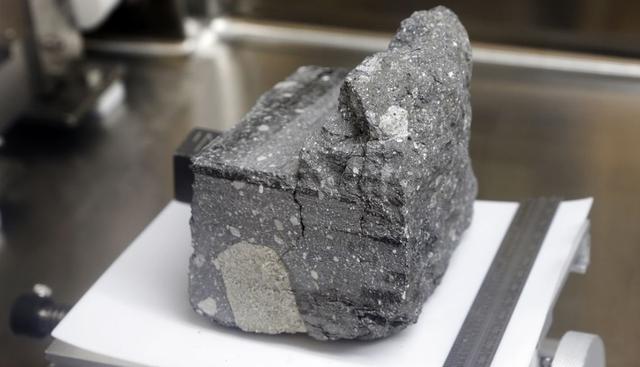 FOTO 4 | muestras de roca lunar selladas desde las misiones Apolo
Una roca de regolito agrietada de suelo lunar datado en 3.200 millones de años y recolectada por el Apolo 15 es exhibida en una caja presurizada con nitrógeno dentro del laboratorio lunar del Centro Espacial Johnson de la NASA, en Houston, en una foto del 17 de junio de 2019 (Foto: Michael Wyke/AP).