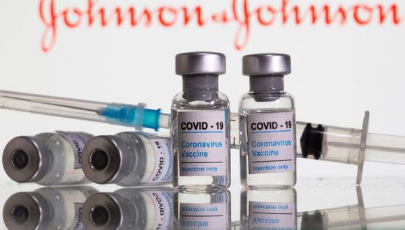 En esta ilustración tomada el 9 de febrero de 2021, se ven viales etiquetados como "Vacuna contra el coronavirus COVID-19" delante del logotipo de Johnson & Johnson.  (REUTERS/Dado Ruvic).