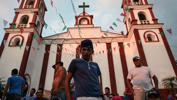 Migrantes hondureños que forman parte de una caravana que se dirige a los EE. UU., permanecen en la plaza principal de Pijijiapan, estado de Chiapas, México, el 25 de octubre de 2018. (Foto de Guillermo Arias / AFP)