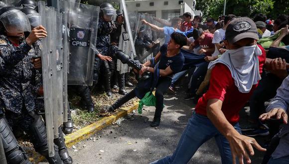 Jóvenes se enfrentan con miembros de la Policía Nacional Bolivariana (PNB) en medio de una protesta de universitarios en Caracas (Venezuela), en una fotografía de archivo. EFE/Rayner Peña R.