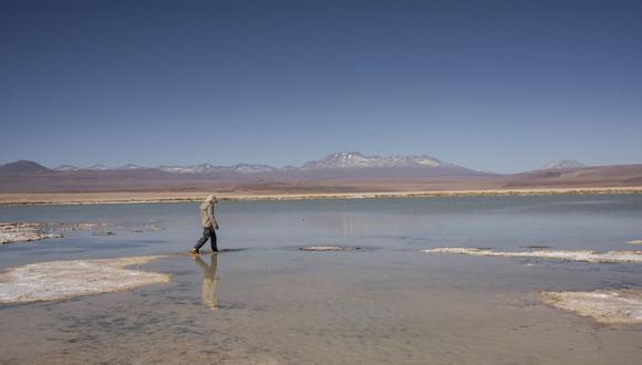 A worker walks into La Punta lagoon Lithium mine to measure water levels at the Atacama Desert, Chile, on Wednesday, July 21st,2021. Albemarle Corp., the world's biggest producer of lithium, is fast-tracking advanced forms of the metal that could result in better batteries for electric vehicles. Photographer: Cristobal Olivares/Bloomberg