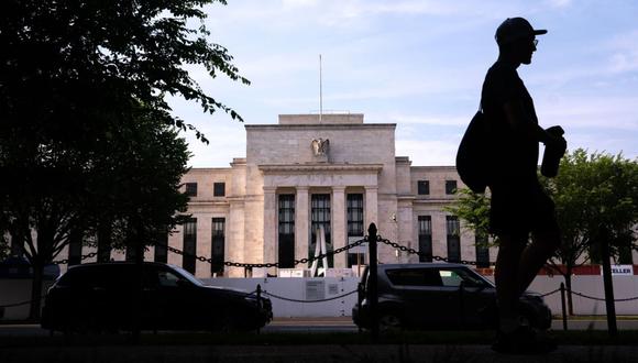 A pedestrian passes the Marriner S. Eccles Federal Reserve building in Washington, DC.