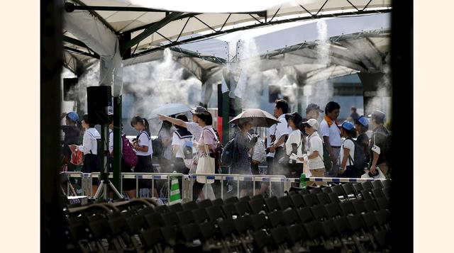 Algunas personas van rezando por las víctimas de Hiroshima de 1945 en el Peace Memorial Park de Japón por la conmemoración del aniversario 70 del ataque de la primera bomba atómica lanzada sobre la ciudad japonesa. (Foto: AP)