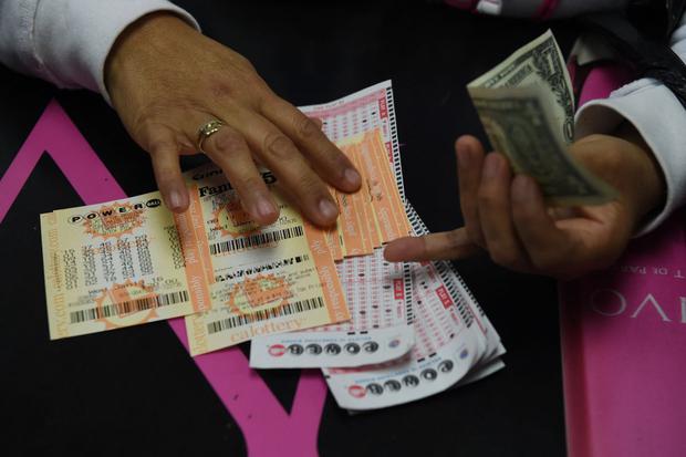Aquí una clienta recoge sus boletos de lotería Powerball de California en la famosa licorería Bluebird (Foto: Mark Ralston / AFP)