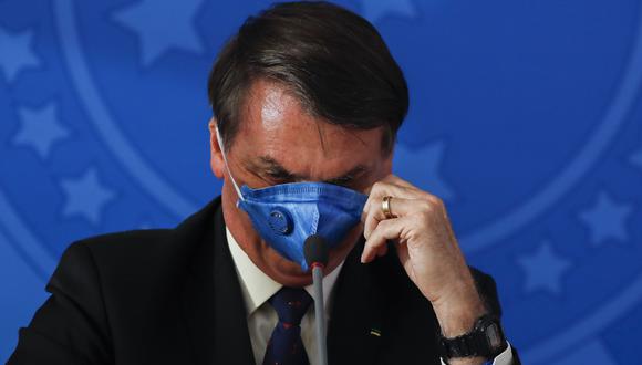 Jair Bolsonaro llama al coronavirus como "gripecita" o "resfriadito" y ha exigido el fin del confinamiento masivo y ha pedido a los brasileños que vuelvan a trabajar. (Foto: AFP)