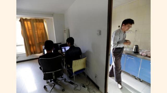 Wu Yaxiong (a la derecha), CEO de N-Wei (Beijing) Technology Company Limited, va a buscar agua en la cocina del departamento que alquila como oficina y residencia de empleados en Pekín, China. (Foto: Reuters)
