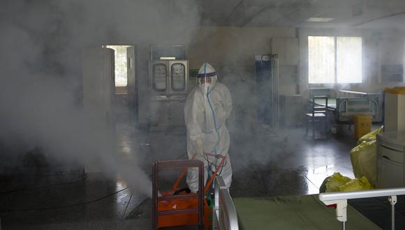 Un trabajador fumiga un hospital en la lucha por detener la propagación del coronavirus. (Foto: AFP)