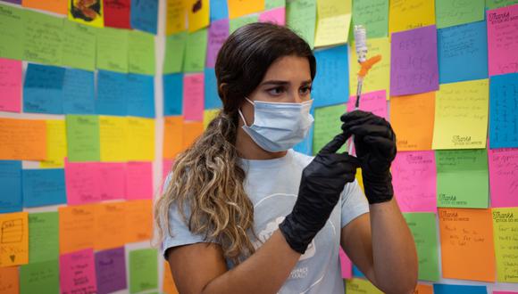 A healthcare worker prepares a dose of the Novavax Covid-19 vaccine at a pharmacy in Schwenksville, Pennsylvania, US, on Monday, Aug. 1, 2022. Novavax's protein-based Covid-19 vaccine received long-sought US emergency-use authorization in July, but use is likely to be limited. Photographer: Hannah Beier/Bloomberg