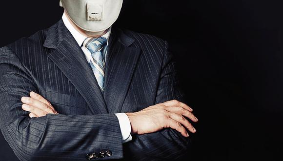Confident man in medical face mask on black background