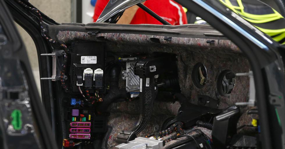 FOTO 7 | Cableado, no cansado
Cableado eléctrico y fusibles expuestos antes de la instalación del monitor. Una vez terminado, se verá simple y minimalista por fuera y esconderá tecnologías complejas por dentro. Detrás del volante, una pantalla grande permite cambiar las configuraciones para ver tres de los cinco medidores tradicionales que muestran la velocidad, la revolución del motor y los modos de conducción. El resto de la consola central ofrece capacidades de pantalla táctil para controlar sonido, temperatura, navegación, cámaras exteriores, calentadores de asientos y otros sistemas de confort y entretenimiento. Fotógrafo: Michaela Handrek-Rehle / Bloomberg