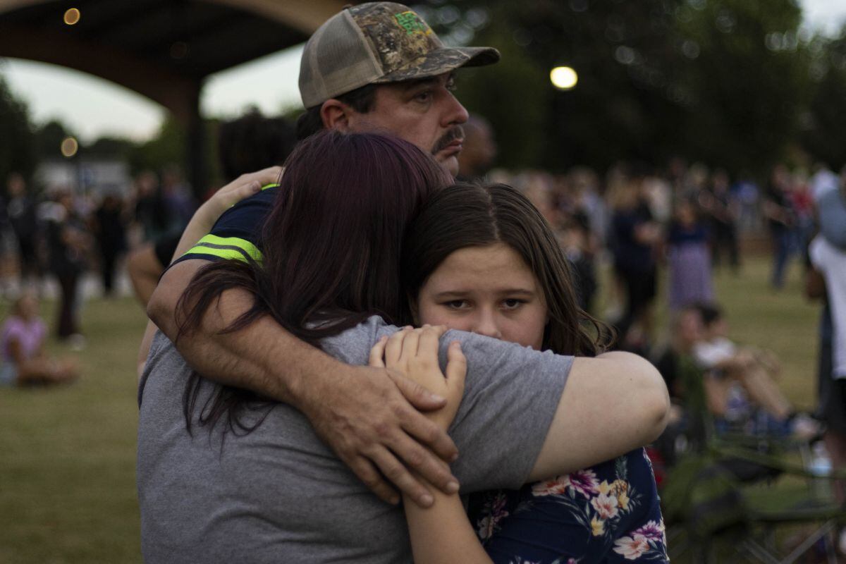 Una familia se abraza durante una vigilia por el tiroteo en la escuela secundaria Apalachee en Jug Tavern Park en Winder, Georgia, el 4 de septiembre de 2024 (Foto: Cristian Monterrosa / AFP)