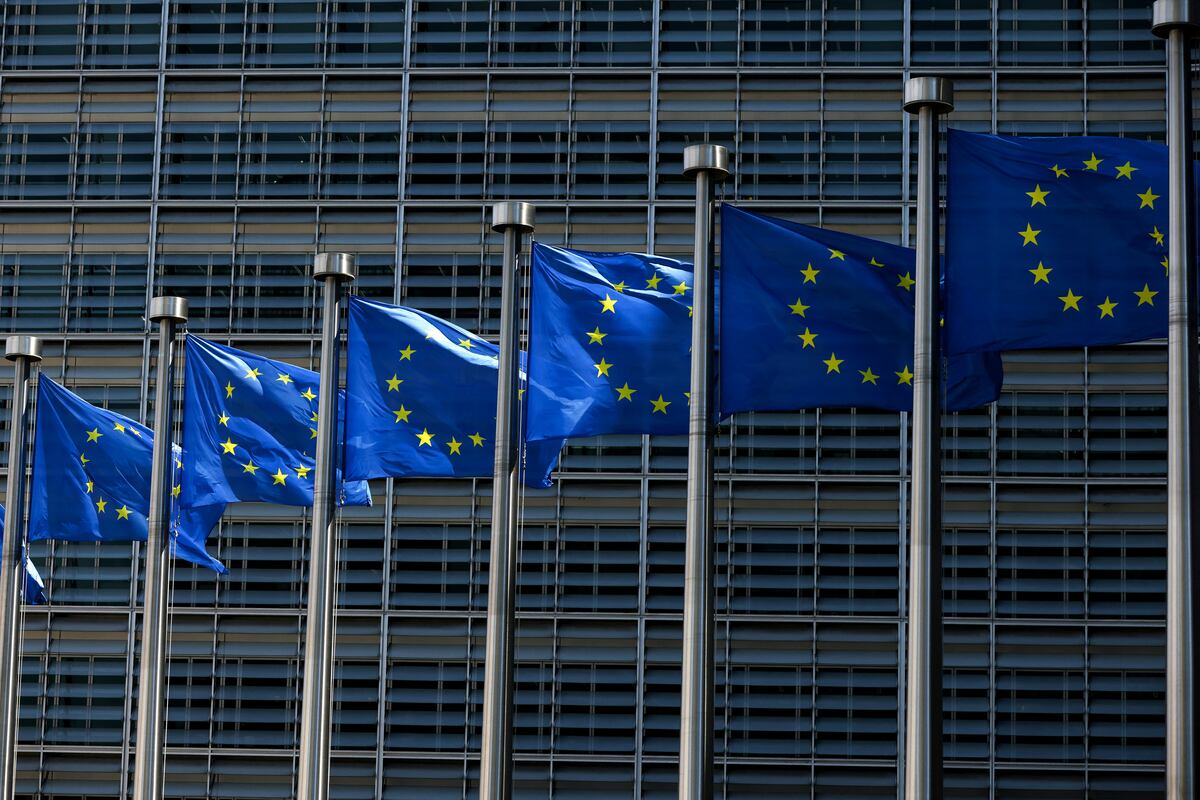 European Union flags fly outside the European Commission building in Brussel on June 16, 2022. (Photo by Kenzo TRIBOUILLARD / AFP)