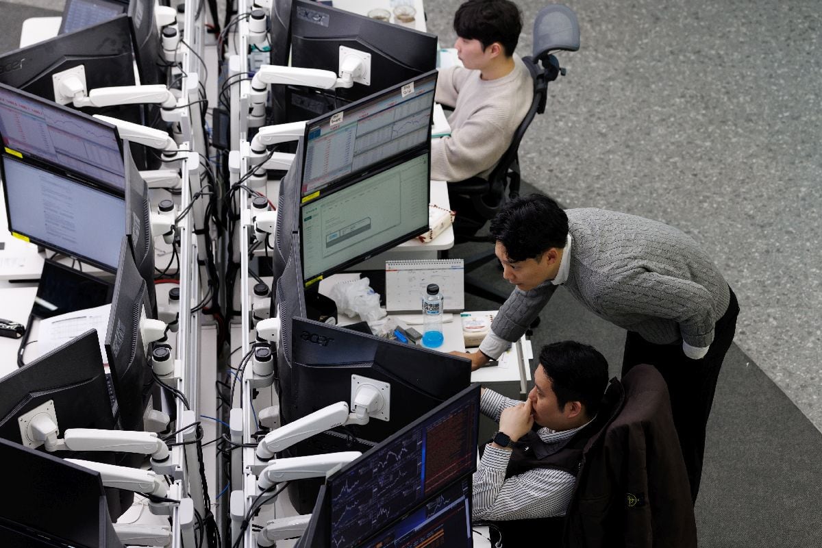 Foreign exchange dealers work inside a trading room at Hana Bank in Seoul, South Korea.