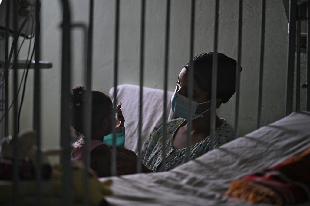 A woman cares for her daughter at the William Soler Pediatric Cardiocenter �a beneficiary of the humanitarian aid brought by the Nuestra America flotilla from Mexico� in Havana, on March 24, 2026. (Photo by Yuri CORTEZ / AFP)