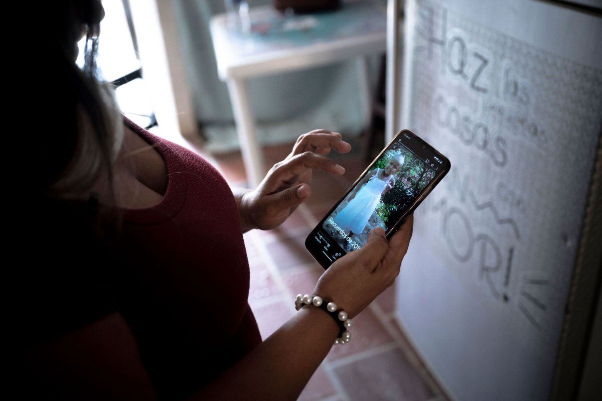 Yohana Rivas Sánchez, madre de la pequeña Valery muestra una fotografía de la niña cuando estaba recibiendo el tratamiento de quimioterapia. Fotógrafo: Nadege Mazars para Bloomberg Businessweek