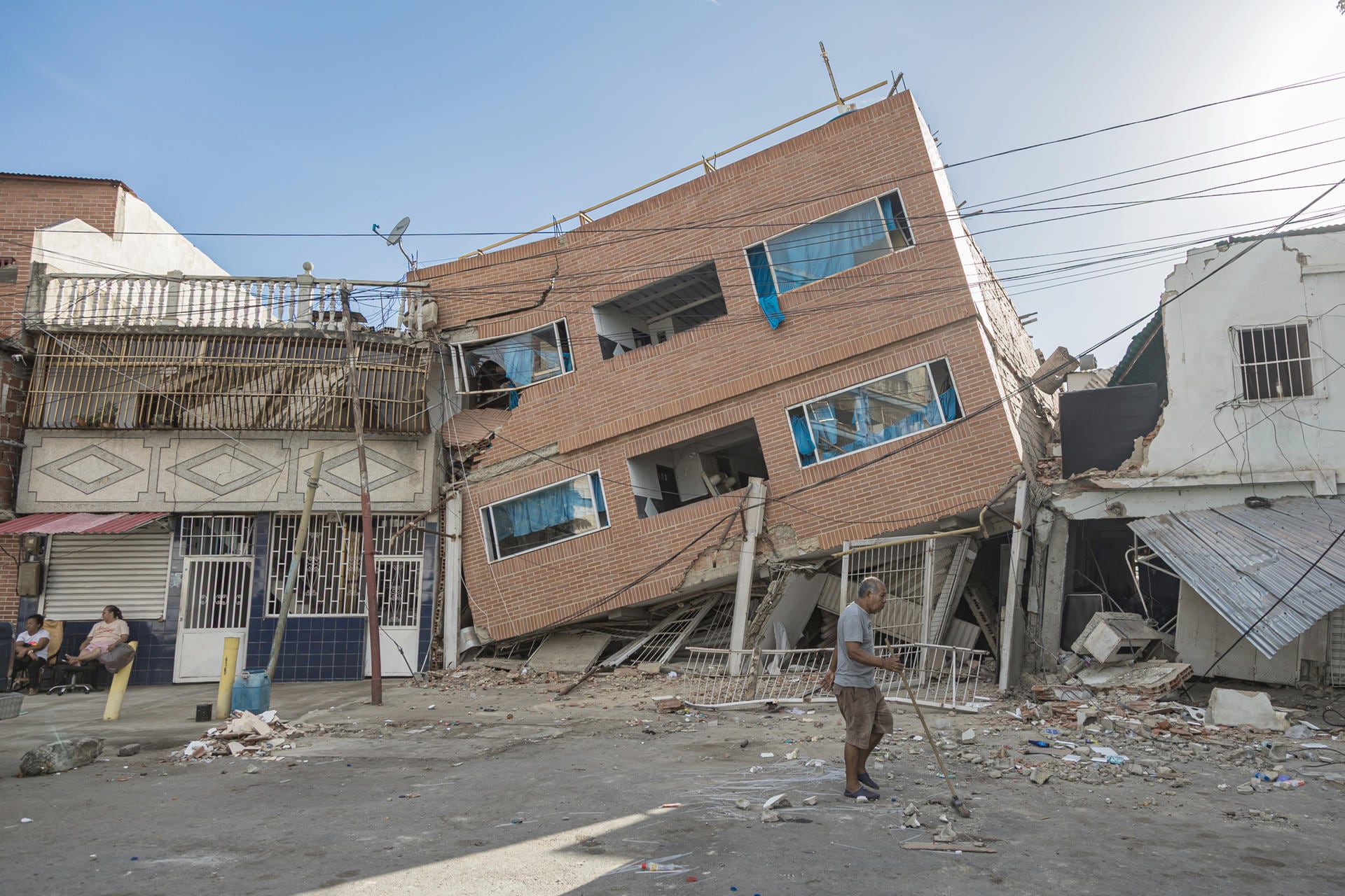 Un hombre camina frente a edificaciones destruidas por los terremotos en Catia La Mar, estado La Guaira, Venezuela. (EFE/ Henry Chirinos).