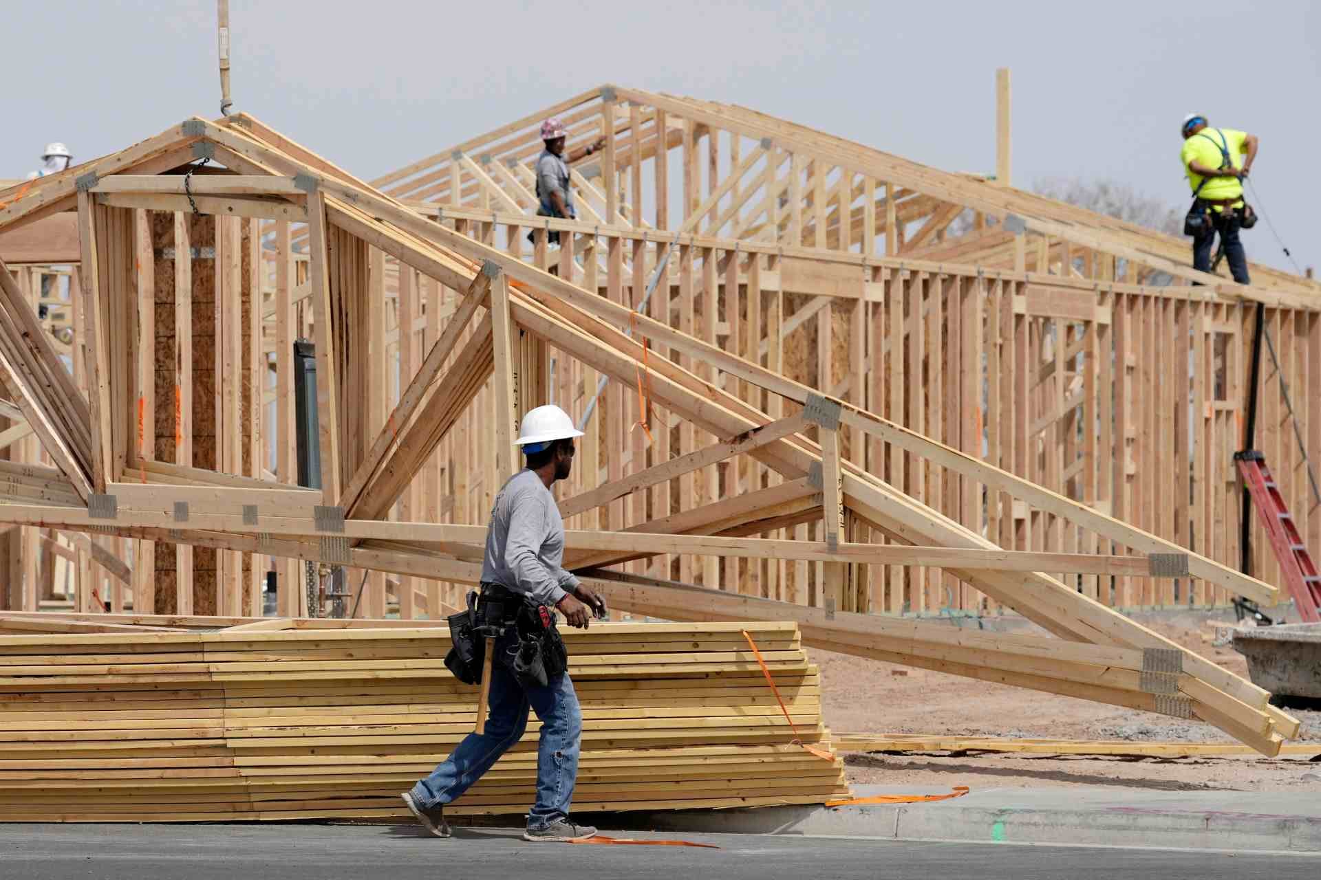 Trabajadores de la construcción instalan un techo de madera en una casa recién construida, el martes 1 de abril de 2025, en Laveen, Arizona. (AP Foto/Ross D. Franklin, Archivo)