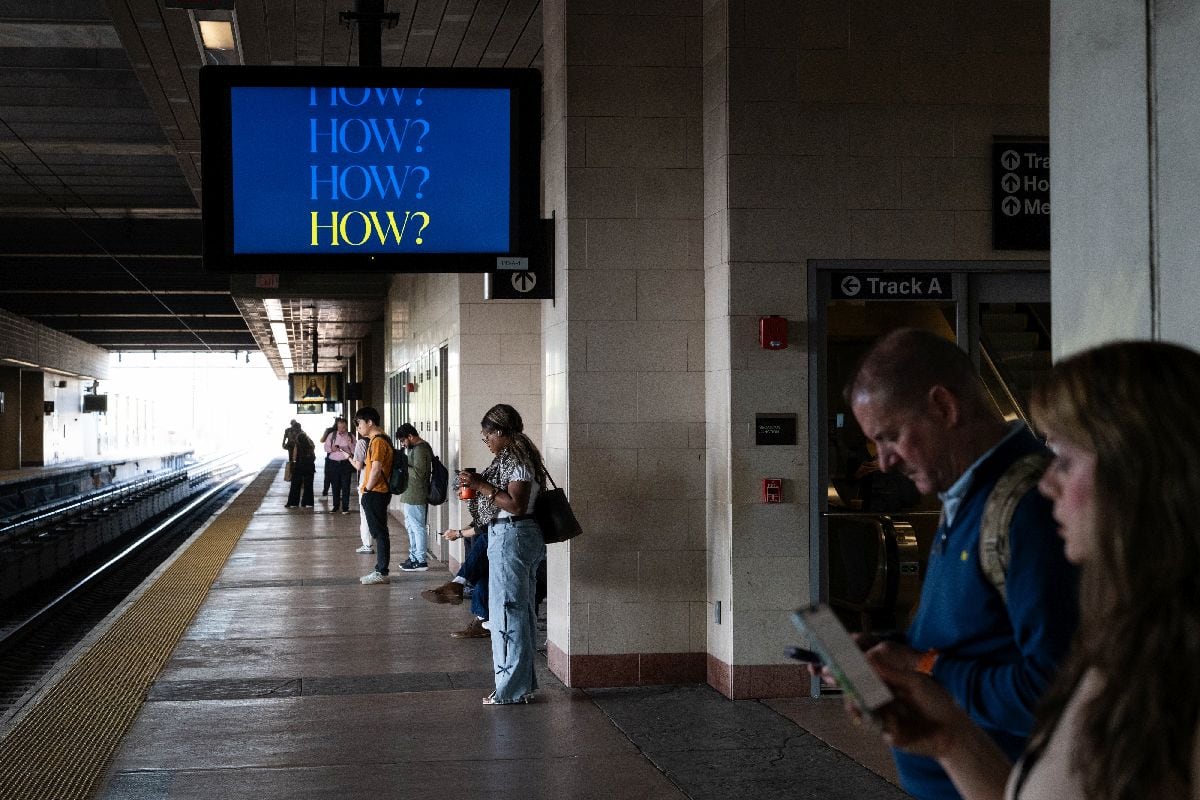 Commuters wait to board a New Jersey Transit train at Secaucus Junction station.