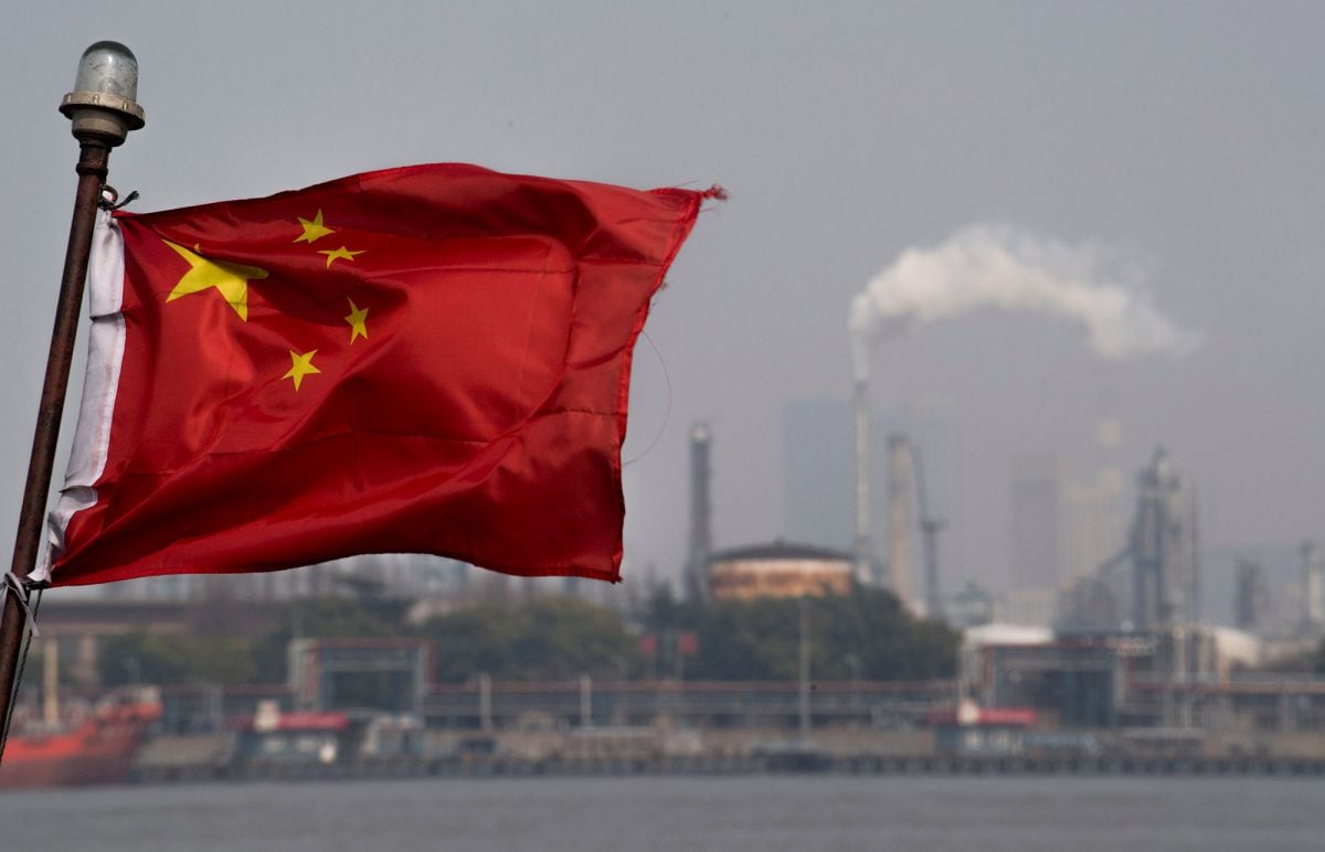 A Chinese flag flutters in front of the Shanghai Gaoqiao Company Refinery in Shanghai.