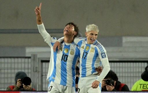Argentina's midfielder Paulo Dybala (L) celebrates with teammate midfielder Enzo Fernandez after scoring during the 2026 FIFA World Cup South American qualifiers football match between Argentina and Chile at the Mas Monumental stadium in Buenos Aires on September 5, 2024. (Photo by JUAN MABROMATA / AFP)