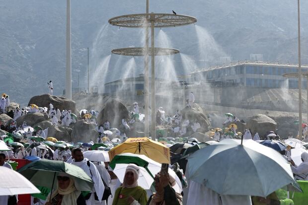 (FILES) Mist dispensers cool Muslim pilgrims at the base of Saudi Arabia's Mount Arafat, also known as Jabal al-Rahma or Mount of Mercy, during the climax of the Hajj pilgrimage on June 15, 2024. (Photo by FADEL SENNA / AFP)