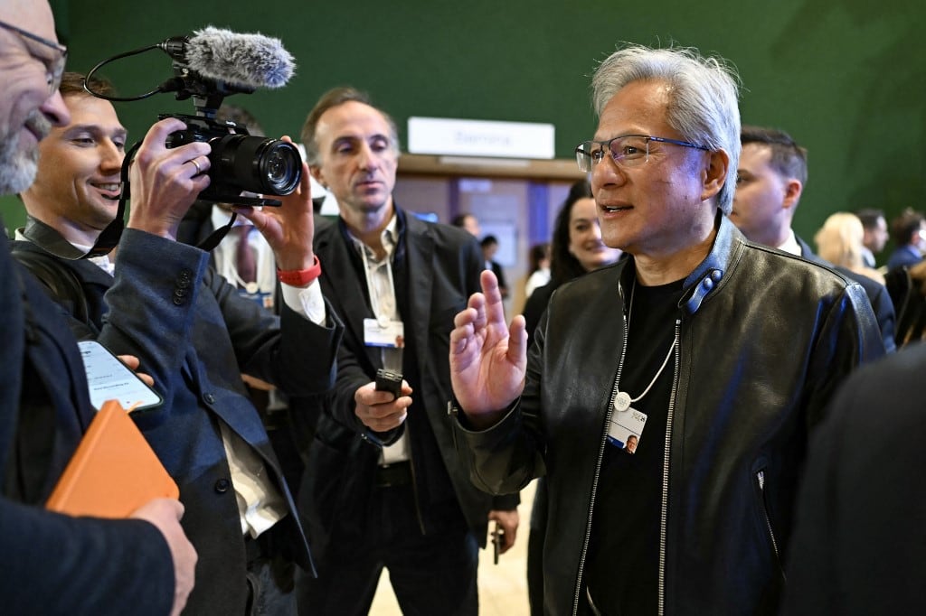 El fundador y director ejecutivo de Nvidia, Jensen Huang, gesticula, flanqueado por periodistas, al despedirse de una recepción con líderes empresariales junto al presidente de Estados Unidos, en el marco de la reunión anual del Foro Económico Mundial (FEM) en Davos el 21 de enero de 2026. El Foro Económico Mundial se celebra en Davos del 19 al 23 de enero de 2026. (Foto de Fabrice COFFRINI / AFP)
