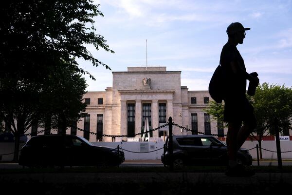 A pedestrian passes the Marriner S. Eccles Federal Reserve building in Washington.