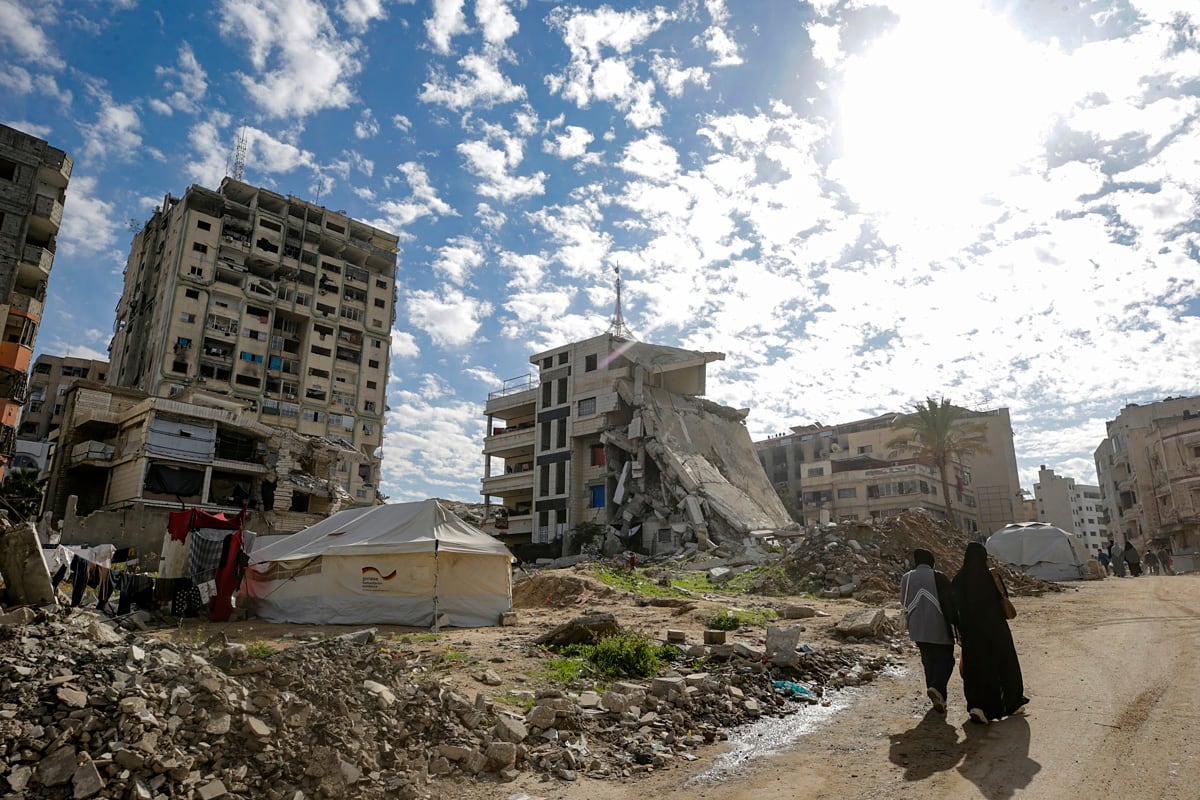 Palestinos caminan cerca de las ruinas de casas en la ciudad de Gaza, Franja de Gaza, el 2 de diciembre de 2025, en medio de un alto el fuego entre Israel y Hamas. (EFE/EPA/MOHAMMED SABER)