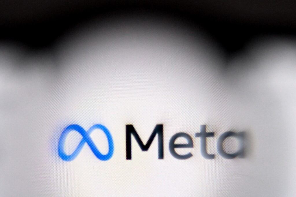 This photo illustration created on January 8, 2025, in Frankfurt am Main, western Germany, shows the media giant Meta's logo displayed on a smartphone. Social media giant Meta on January 7, 2025 slashed its content moderation policies, including ending its US fact-checking program on Facebook and Instagram, in a major shift that conforms with the priorities of incoming president Donald Trump. The EU on January 8 rejected Meta chief Mark Zuckerberg's charge that the bloc engaged in "censorship" with its tech regulations. (Photo by Kirill KUDRYAVTSEV / AFP)