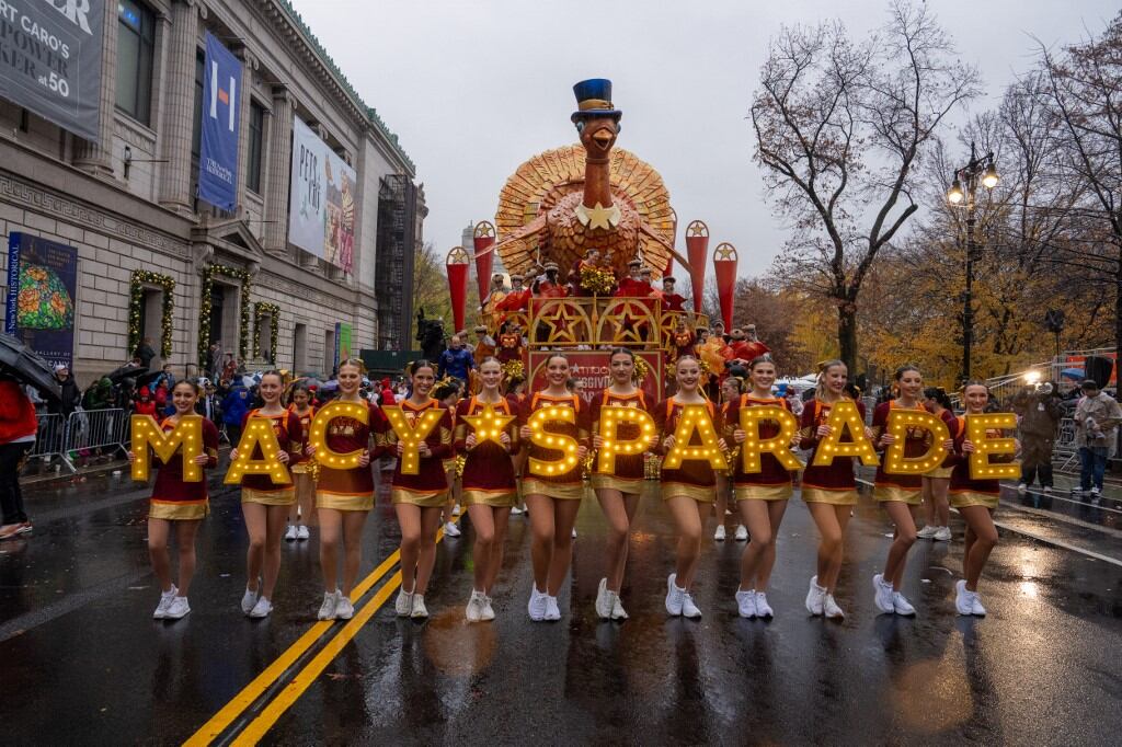 Cheerleaders perform in the rain during the annual Macy's Thanksgiving Day Parade in New York City on November 28, 2024. (Photo by David Dee Delgado / AFP)