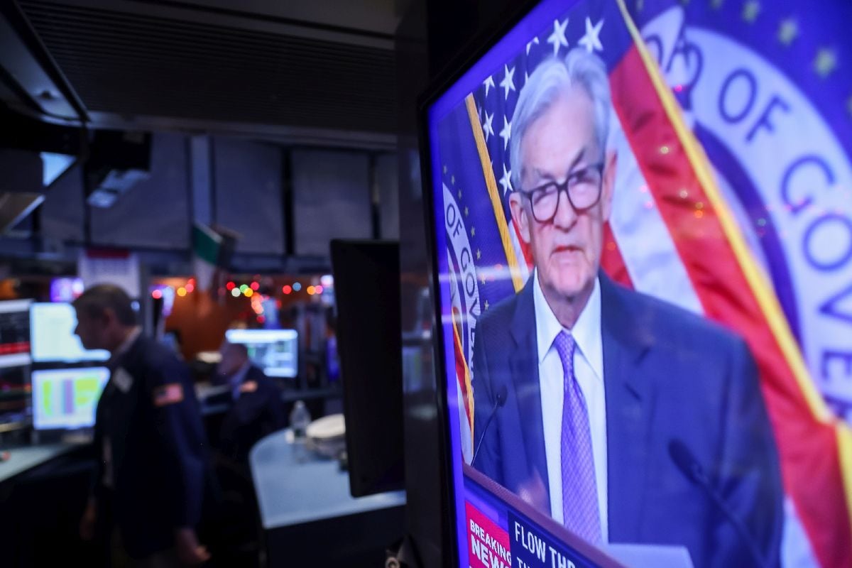 A television station broadcasts Jerome Powell speaking on the floor of the New York Stock Exchange on Dec. 10.
