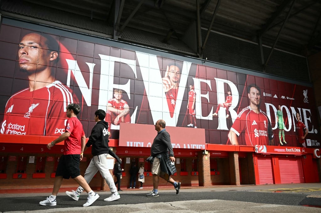 Members of the public walk beside Liverpool's Anfield football stadium on the day that Swedish striker Alexander Isak arrives at he club in Liverpool, north-west England on September 1, 2025, transfer deadline day. (Photo by Paul ELLIS / AFP)