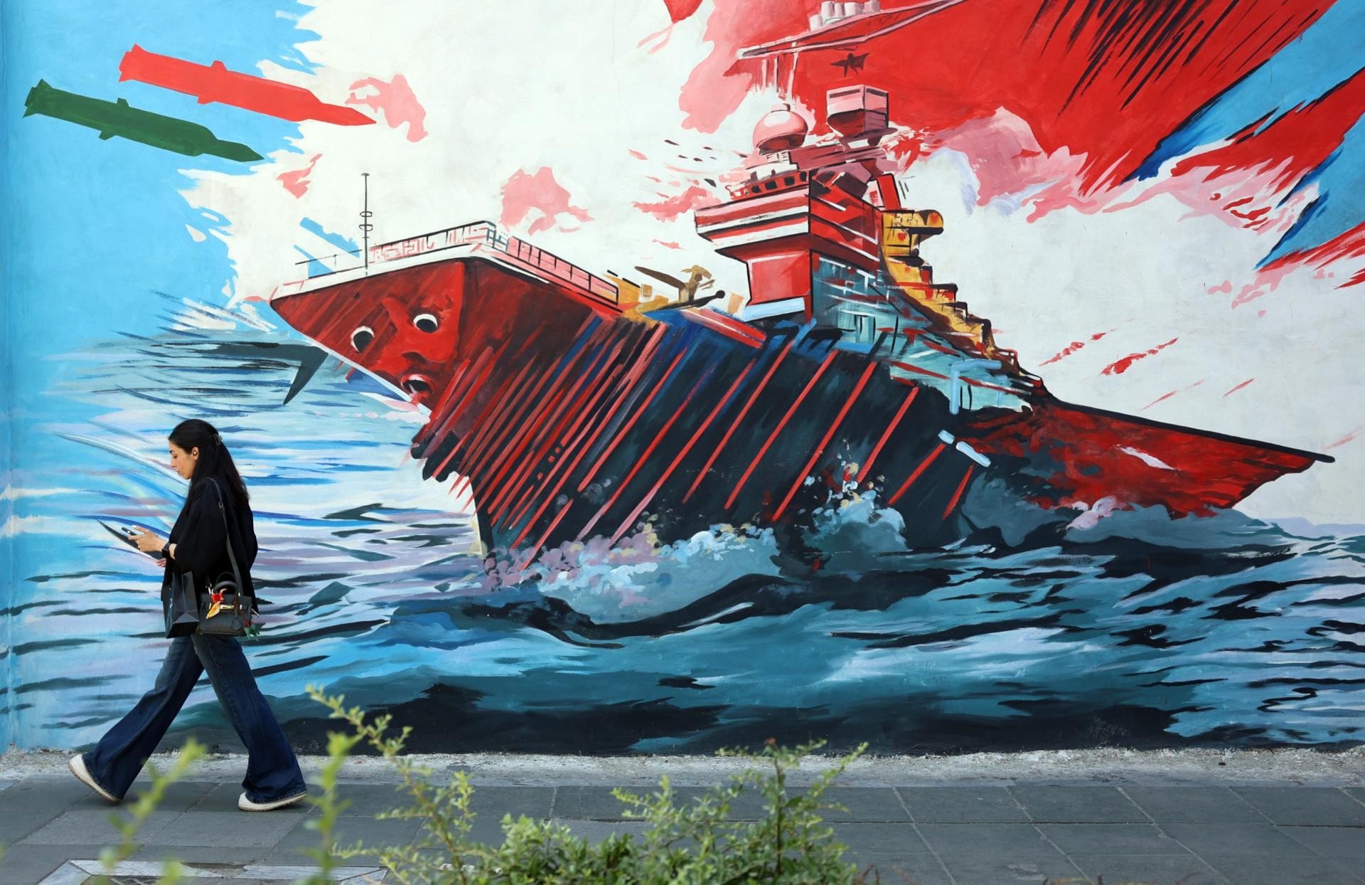Una mujer de Irán camina junto a un mural antiestadounidense e israelí en Teherán, el 3 de junio de 2026. (Foto: EFE)