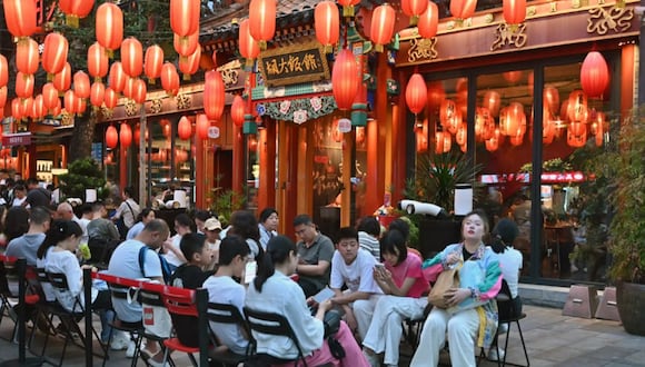 Gente esperando para cenar en un restaurante de Pekín. |  ADEK BERRY / AFP