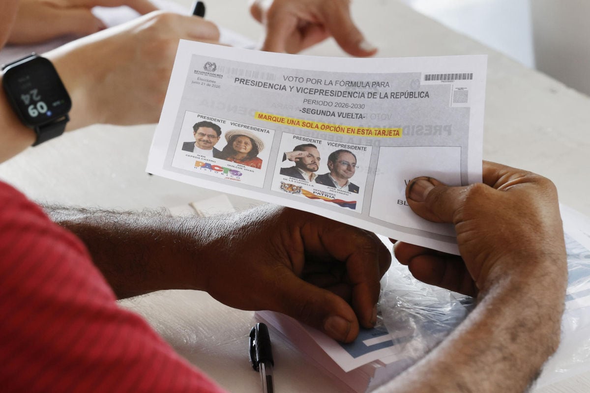 Un jurado de votación entrega un tarjetón electoral este domingo, durante la segunda vuelta de las elecciones presidenciales que elegirá quien gobernará a Colombia en el periodo 2026-2030, en Barranquilla. Foto: EFE/ Mauricio Dueñas Castañeda